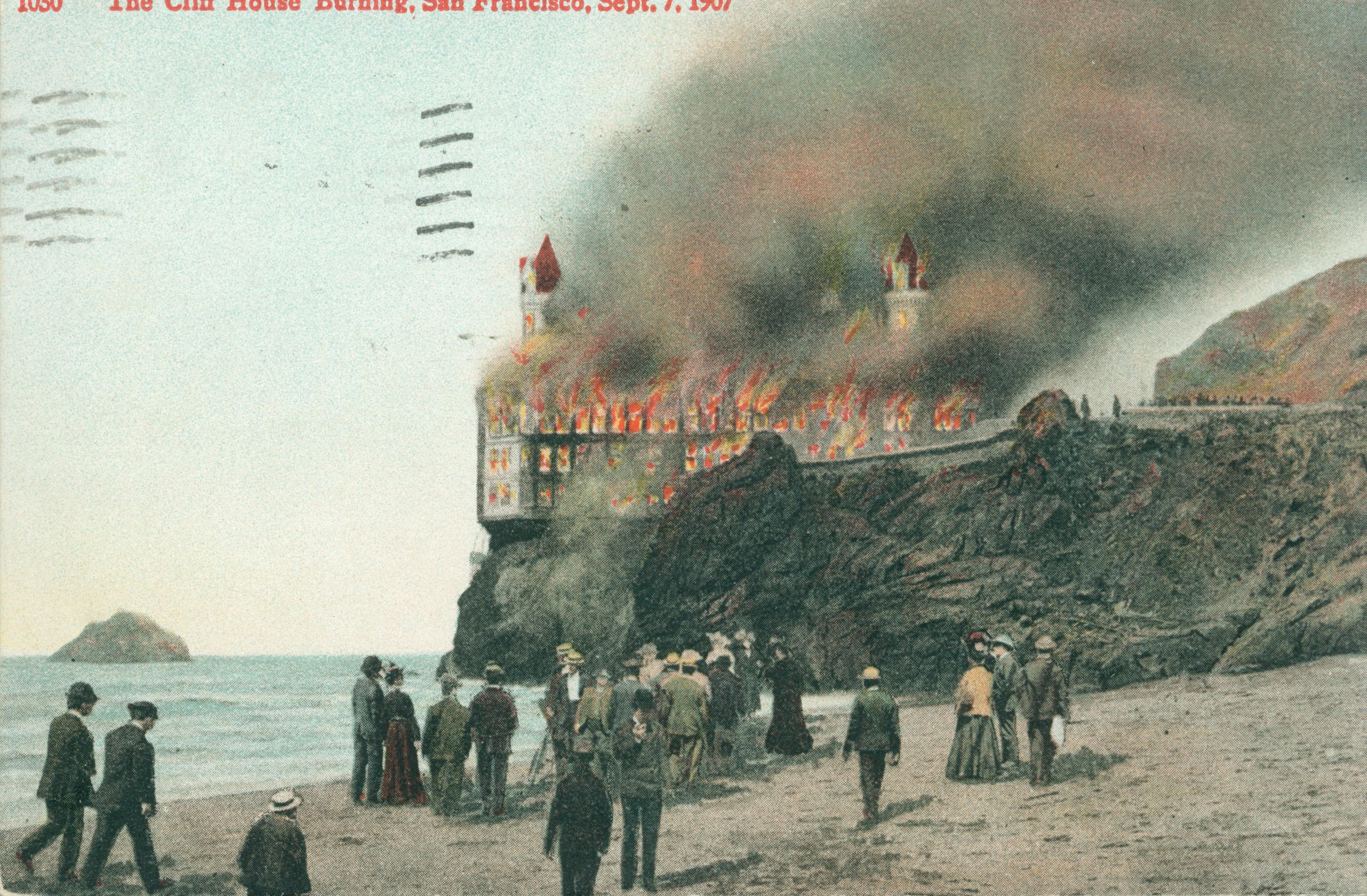 Shows the Cliff House on fire with several individuals looking on from the beach.